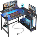 Bestier Gaming Desk with Power Outlets, 42" L-Shaped Computer Desk with LED Lights, Desk with Reversible Storage Shelves & Hooks for Small Spaces, Bedrooms & Offices, Black Carbon Fiber